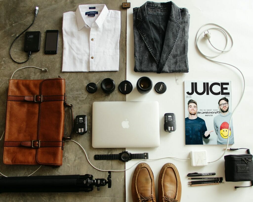 brown leather bag clothes and macbook - Travel Packing List for Europe