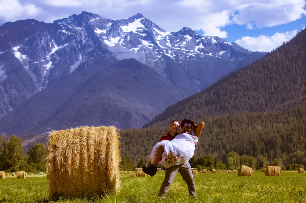 man carrying woman in the hay field - Vacation Instagram Captions