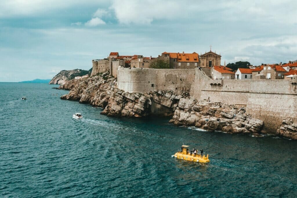 old town on rocky seashore against cloudy sky - Where to stay in Dubrovnik Croatia?